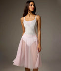 Bodile Julieta mesh rehearsal skirt in pale pink, showing its flowing full-circle shape over a white leotard.