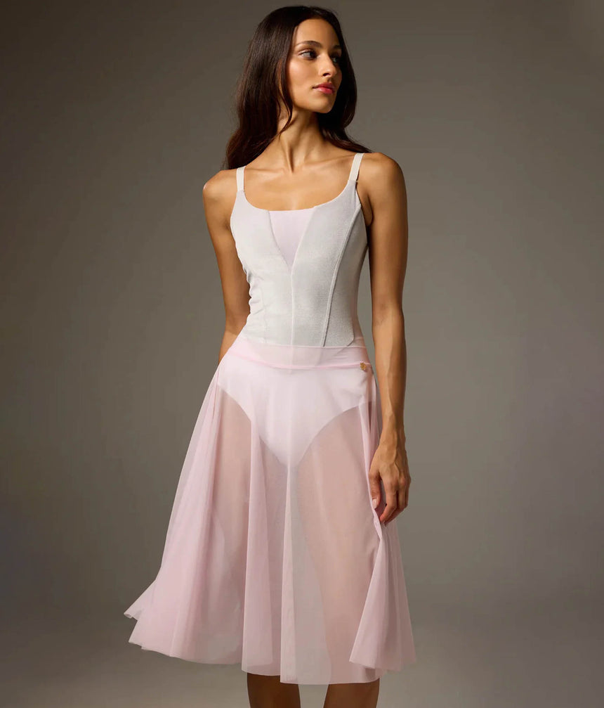 Bodile Julieta mesh rehearsal skirt in pale pink, showing its flowing full-circle shape over a white leotard.