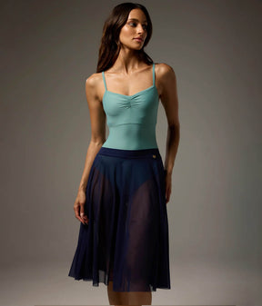 Bodile Julieta full-circle mesh rehearsal skirt in navy, worn over a turquoise leotard.