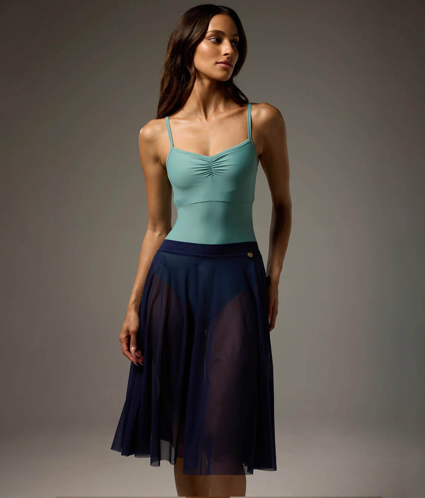 Bodile Julieta full-circle mesh rehearsal skirt in navy, worn over a turquoise leotard.