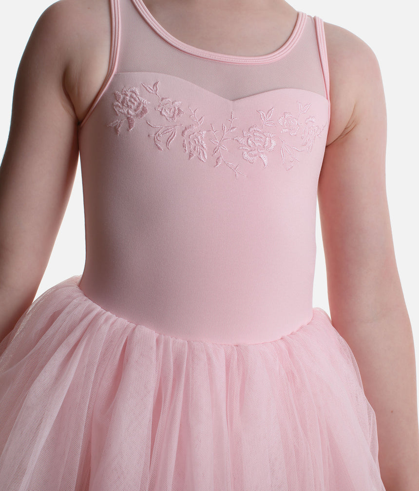 Close-up of tonal floral embroidery and the sweetheart-shaped bodice beneath the round mesh neckline of the pink Mirella Petite Adagio tutu leotard.