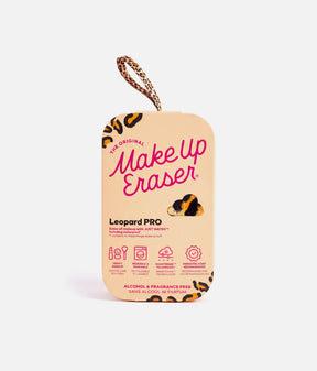 MakeUp Eraser Leopard PRO cloth with black edging and a pink branded ribbon, rolled beside its leopard-detail packaging.