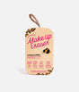 MakeUp Eraser Leopard PRO cloth with black edging and a pink branded ribbon, rolled beside its leopard-detail packaging.