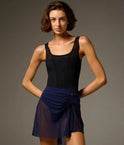 Dancer wearing a Prussian Blue Bodile Mika mesh ballet skirt with gathered ruching and a left-side split over a leotard.