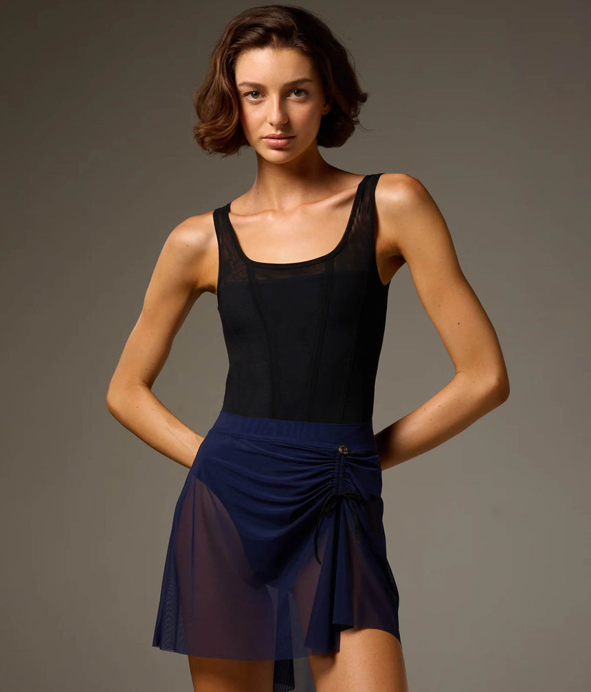 Dancer wearing a Prussian Blue Bodile Mika mesh ballet skirt with gathered ruching and a left-side split over a leotard.