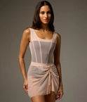 Dancer wearing a Bon Bon Bodile Mika mesh ballet skirt with gathered ruching and a left-side split over a leotard.