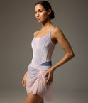 Dancer wearing a blue-grey Bodile Mika mesh ballet skirt with gathered ruching and a left-side split over a long-sleeve leotard.