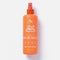 An orange spray bottle of No Nasties Knot A Chance Hair Detangler, featuring a clear cap and orange nozzle, set against a clean white background with a soft shadow.