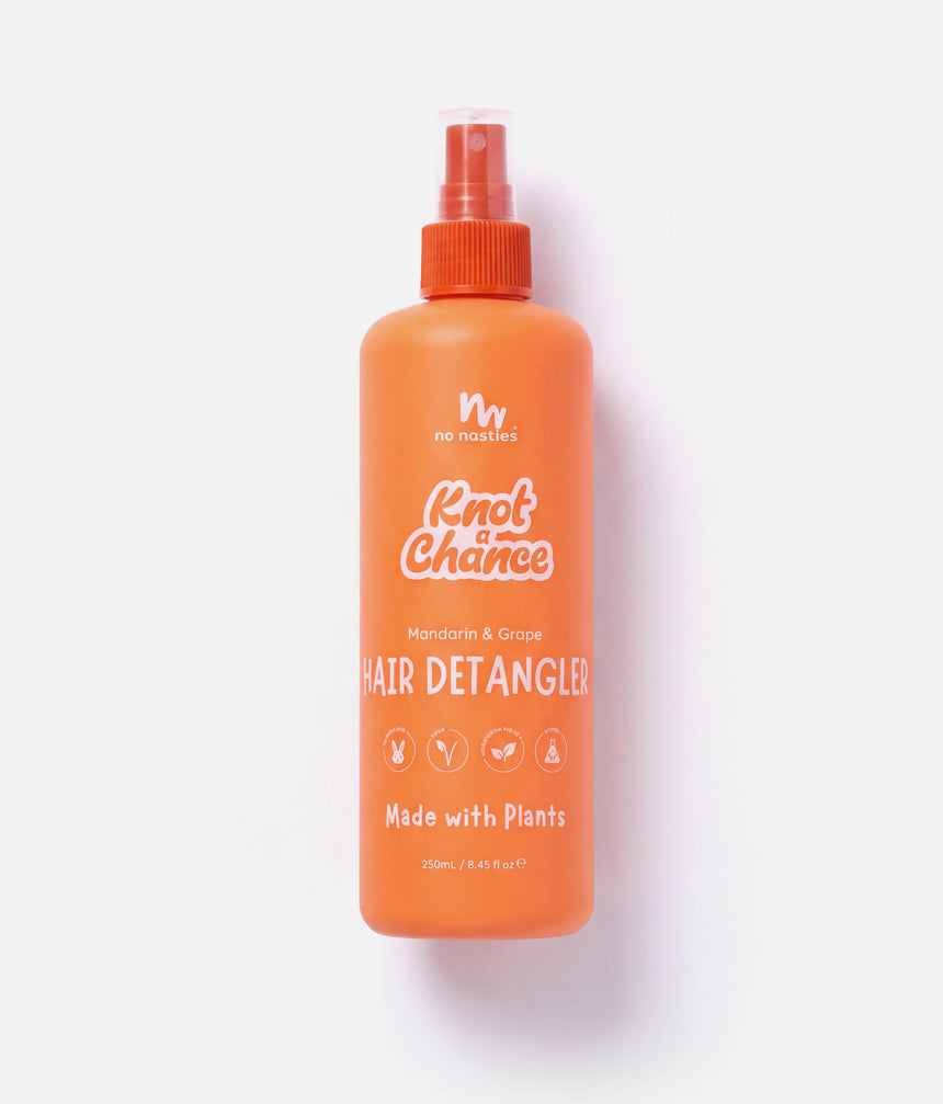 An orange spray bottle of No Nasties Knot A Chance Hair Detangler, featuring a clear cap and orange nozzle, set against a clean white background with a soft shadow.