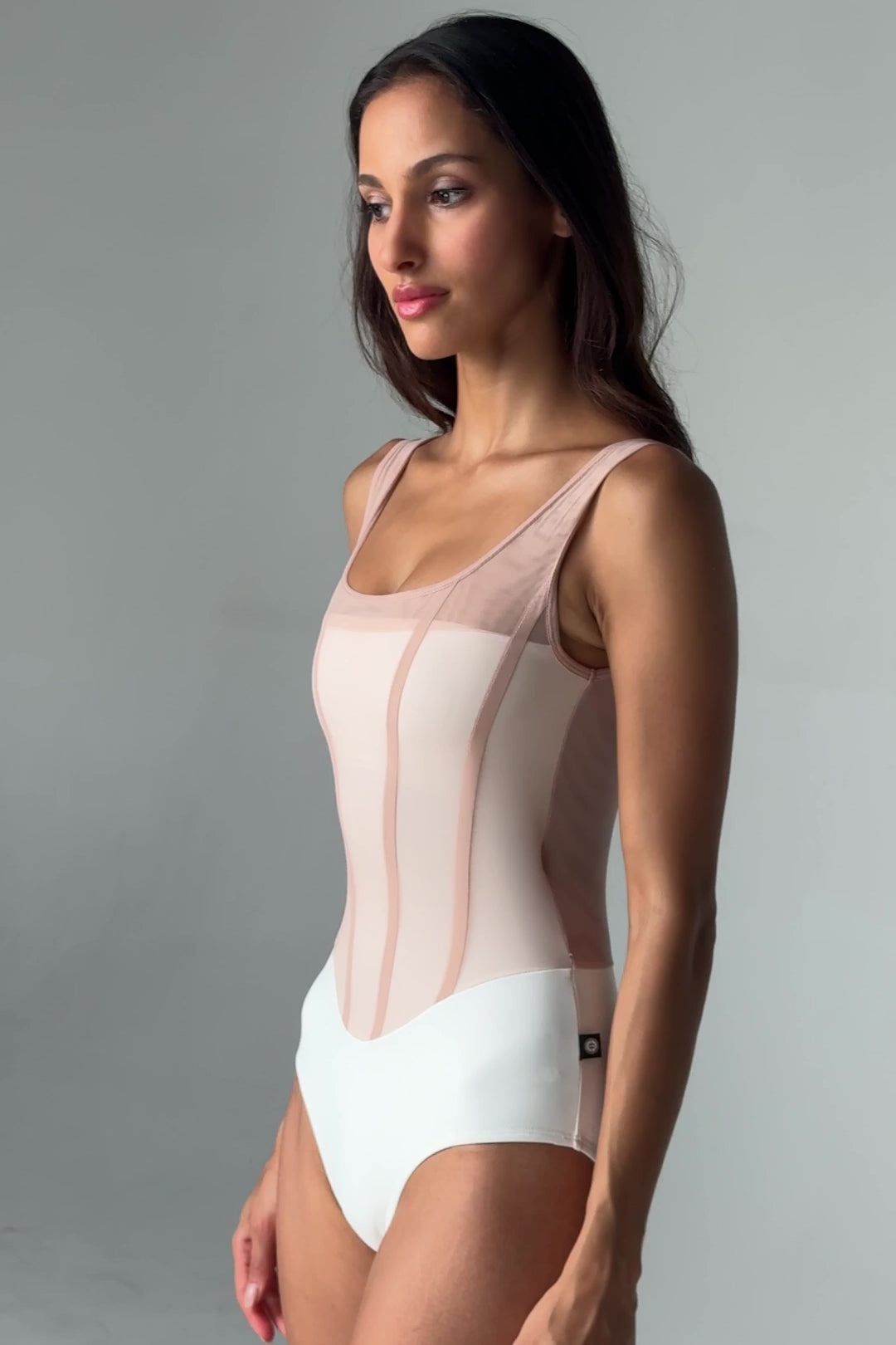 Video of Bodile Sofia Nougat Frost tank ballet leotard with a white body, pale blush mesh overlay and corset-style seams.