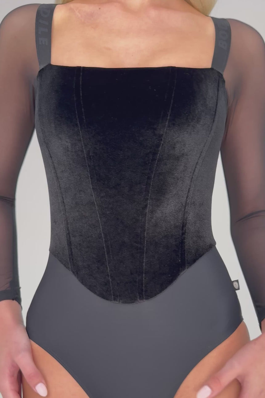 Video of Bodile Valentina Noire Ink Ash black leotard, showing velvet corset-style panels, a square neckline and sheer sleeves.