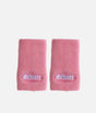 Pair of pink Reisport towelling wristbands laid flat with white embroidered logos