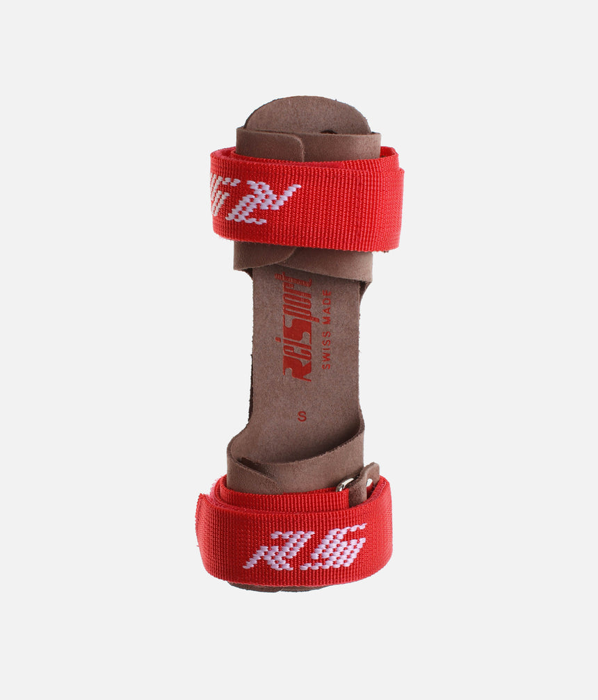 Reisport Universal Junior handguards folded together, showing brown leather palms and red wrist straps