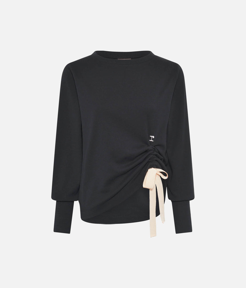 Front view of Repetto S0797 black sweatshirt laid flat, with fitted cuffs, side ruching, pale ribbon bow and small r logo.