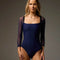 Front of Bodile Saskia Prussian Blue ballet leotard, showing its square neckline, smooth navy body and sheer three-quarter sleeves.