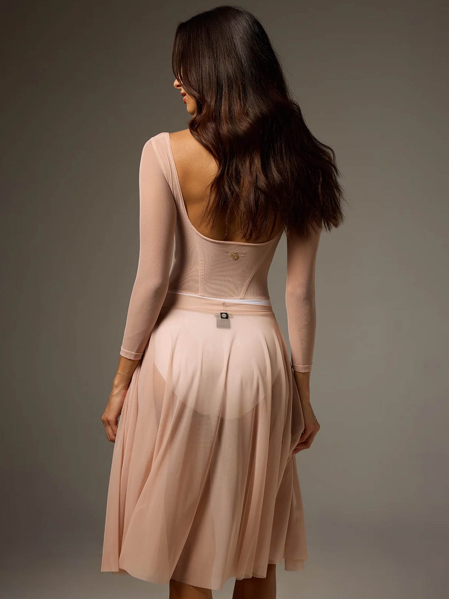 Back of Bodile Sofia Frost Nougat leotard with a deep scoop neckline, worn with a separate flowing blush Julieta mesh skirt.