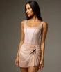 Bodile Sofia Nougat Frost tank leotard styled with a separate short blush mesh skirt featuring ruching and a black ribbon tie.