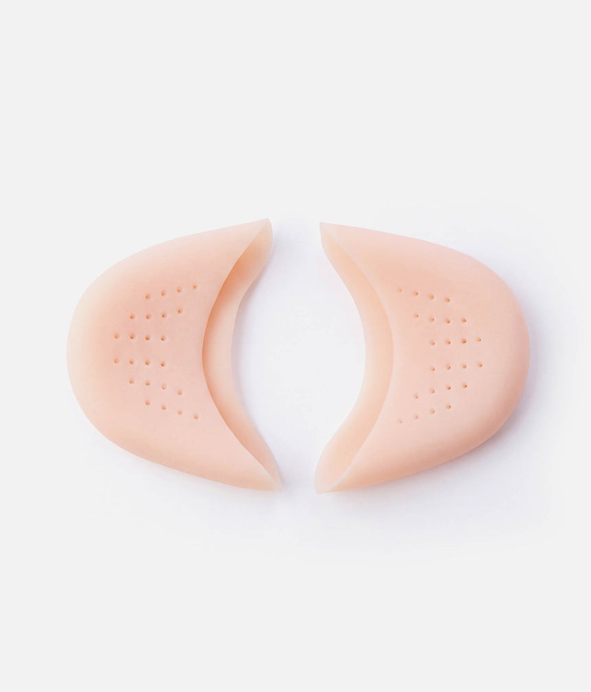 Two Tendu Soft Gel Toe Pads with their openings facing each other and the perforated surfaces visible.