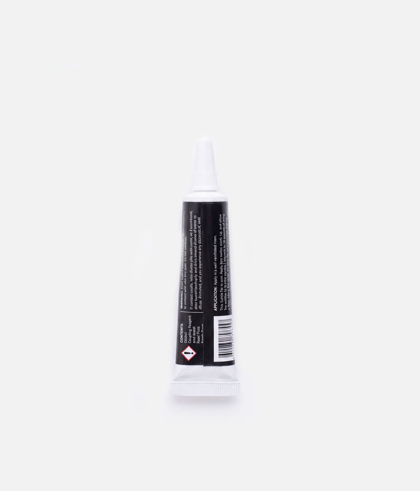 Back of a Tendu Suede Tip Glue tube showing the application and warning panels, barcode and hazard symbol.