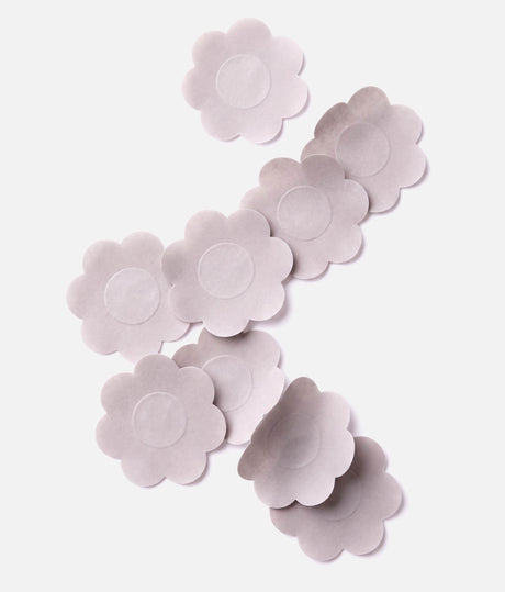 Light nude Tendu Nipple Petals arranged on a white background, showing their flower shape and circular centres.