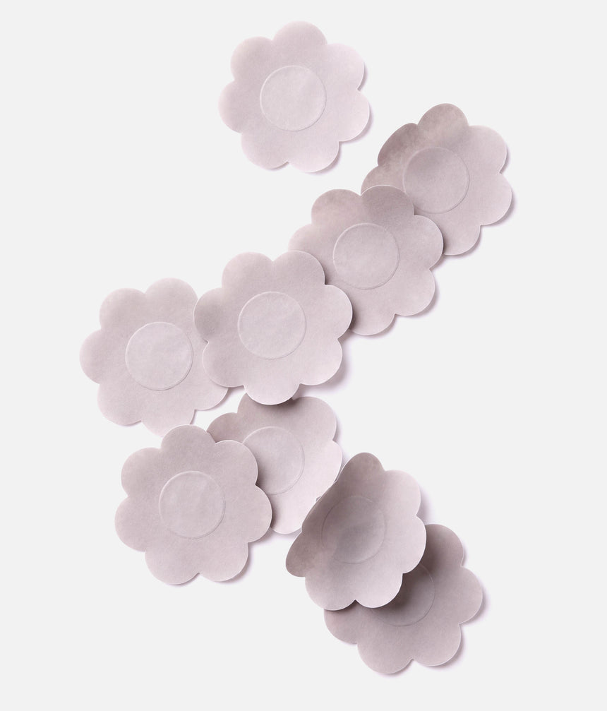 Light nude Tendu Nipple Petals arranged on a white background, showing their flower shape and circular centres.