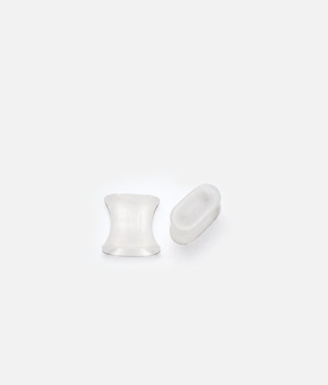 Two translucent Tendu gel toe spacers shown from different angles, highlighting their curved sides and wider edges.