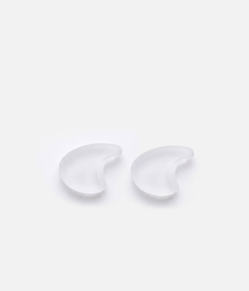 Pair of translucent Tendu Medium Straight Toe Spacers showing their rounded outline and solid gel design.