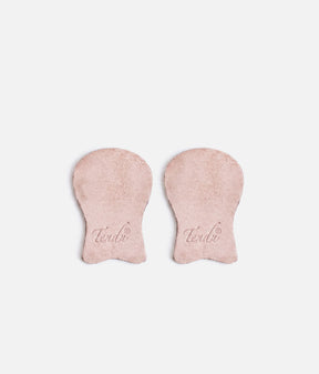 Pair of pale suede Tendu pointe shoe tips laid side by side, showing rounded platform sections, narrower lower tabs and printed Tendu logos.