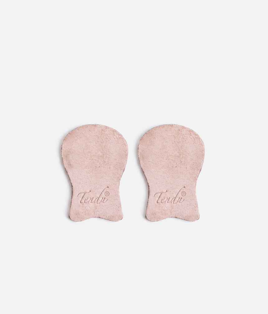 Pair of pale suede Tendu pointe shoe tips laid side by side, showing rounded platform sections, narrower lower tabs and printed Tendu logos.