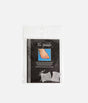Tendu Toe Spreader retail pack containing two clear gel spacers, with a photograph showing placement between the big and second toes.