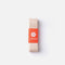 Pale pink-beige Virtisse Stretch Ribbon folded beneath an orange paper band with the white Virtisse flower logo.
