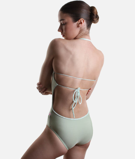 Back view of YUMIKO Kate in Ginko on a dancer, showing fine horizontal straps, an adjustable bow and a low open back.