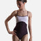 Dancer wearing YUMIKO Denise in Eggplant with White velvet upper panels, Opera trim and a high-cut ballet leg.